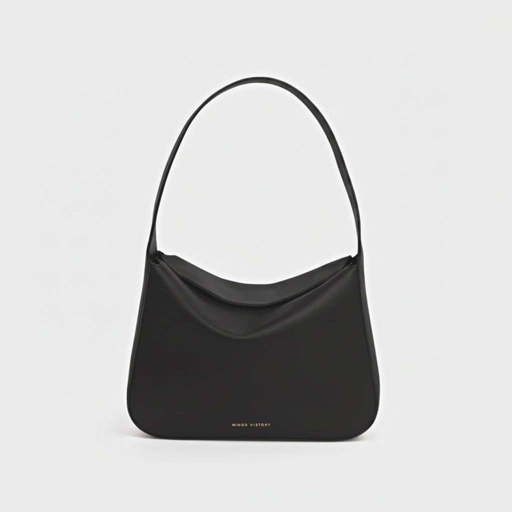 Black handbag on a light gray background -Black