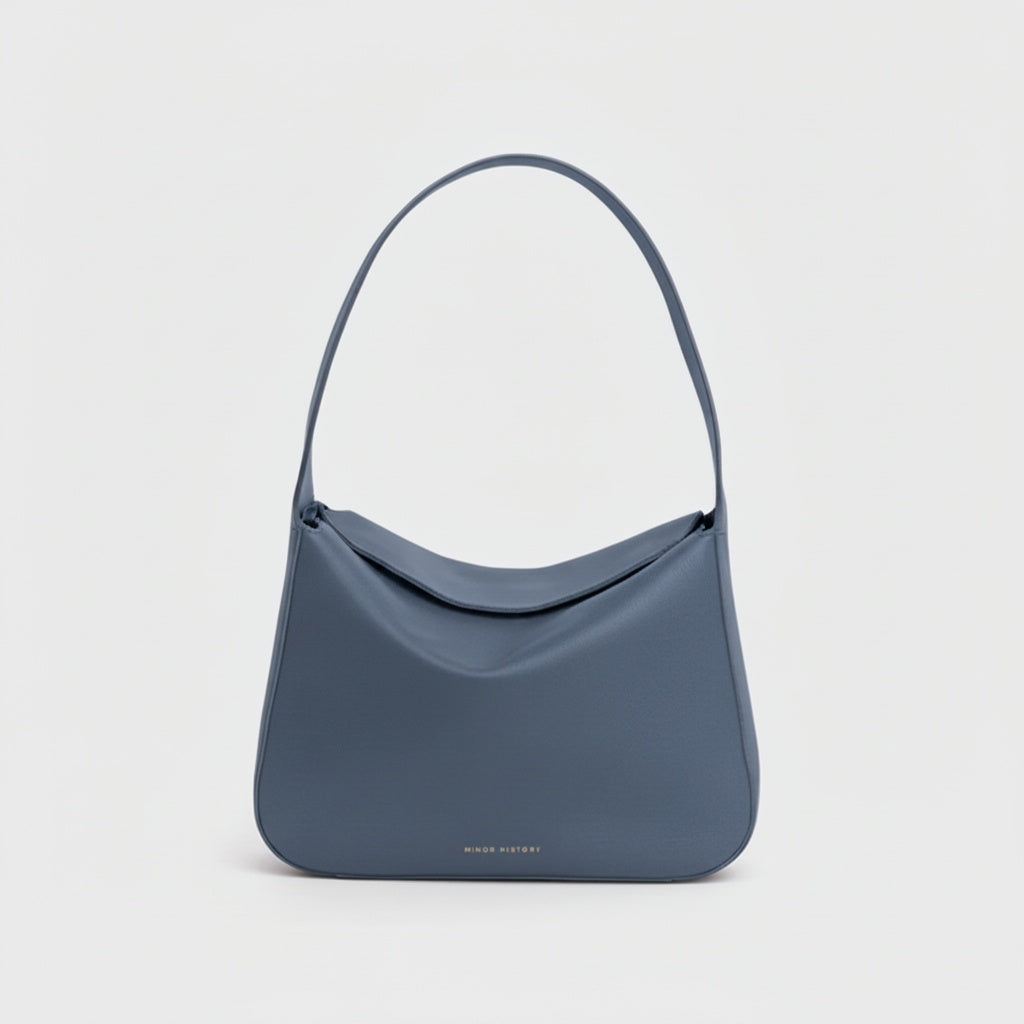 Frame Bag in luxury full-grain leather, styled as a shoulder bag with soft folds - Limelight