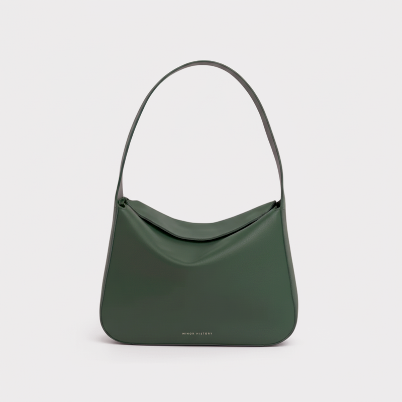 Frame Bag in luxury full-grain leather, styled as a shoulder bag with soft folds - Limelight