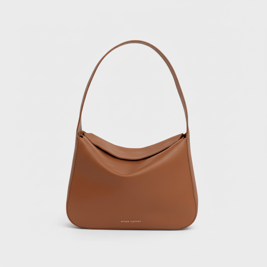 Brown handbag on a light gray background - Saddle