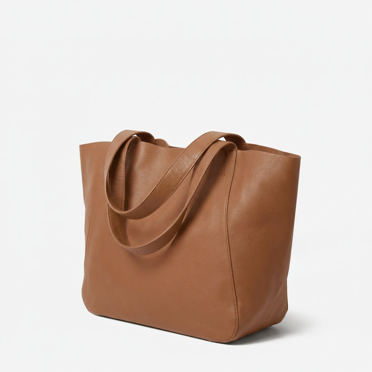 Brown leather tote bag on a light gray background  - Saddle