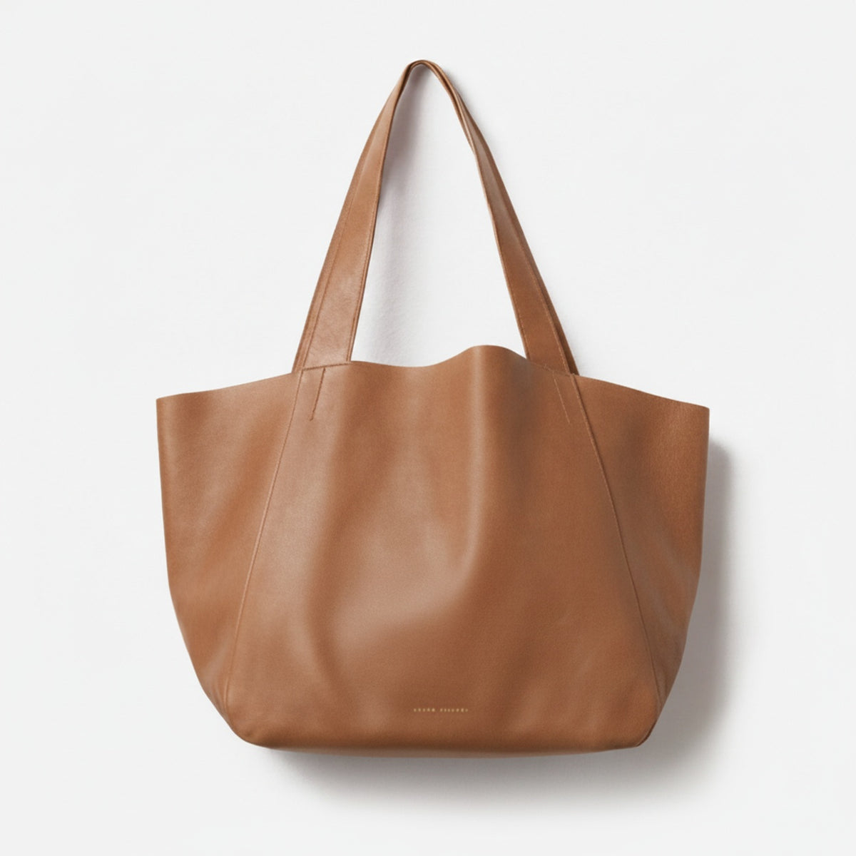 Brown leather tote bag on a white background - Saddle