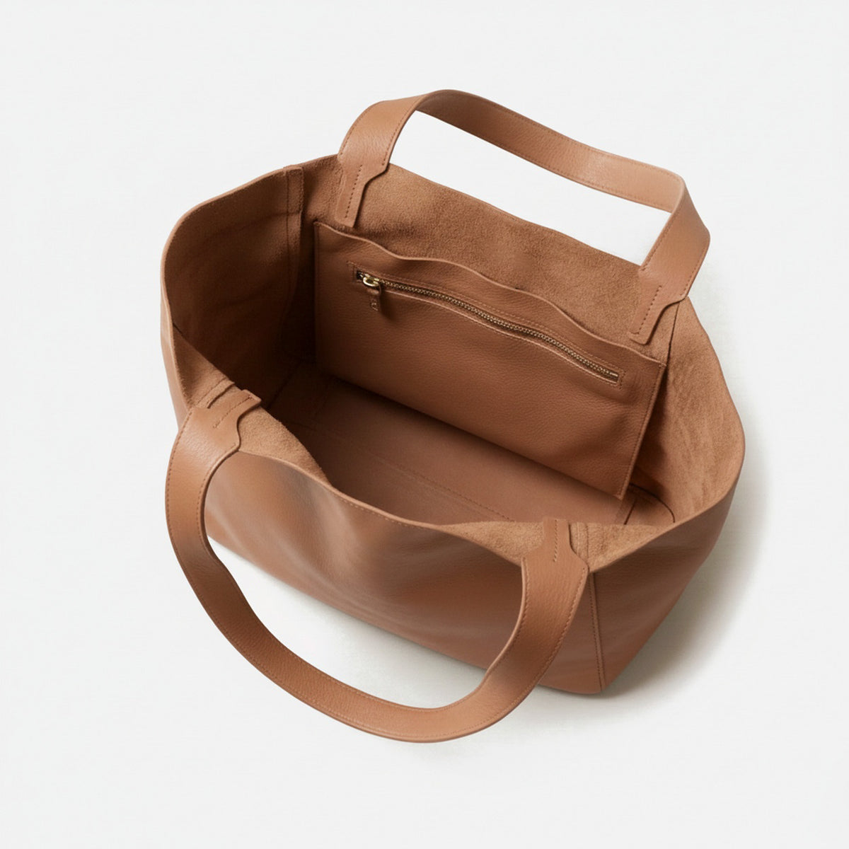 Brown leather handbag on a white background  - Saddle