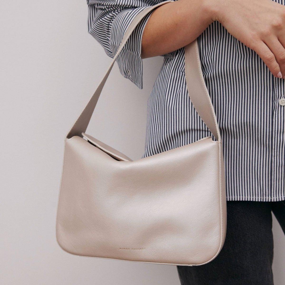 Frame Bag in luxury full-grain leather, detailed studio shot capturing texture and strap design