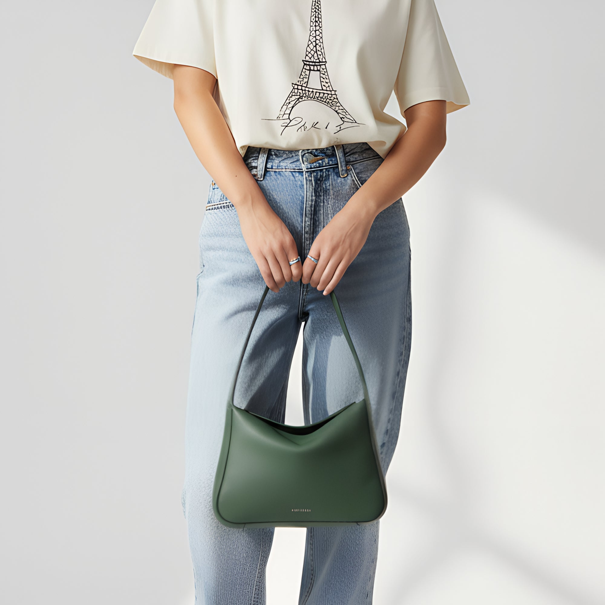 Frame Bag in black full-grain leather, lifestyle setting with neutral outfit pairing - Black