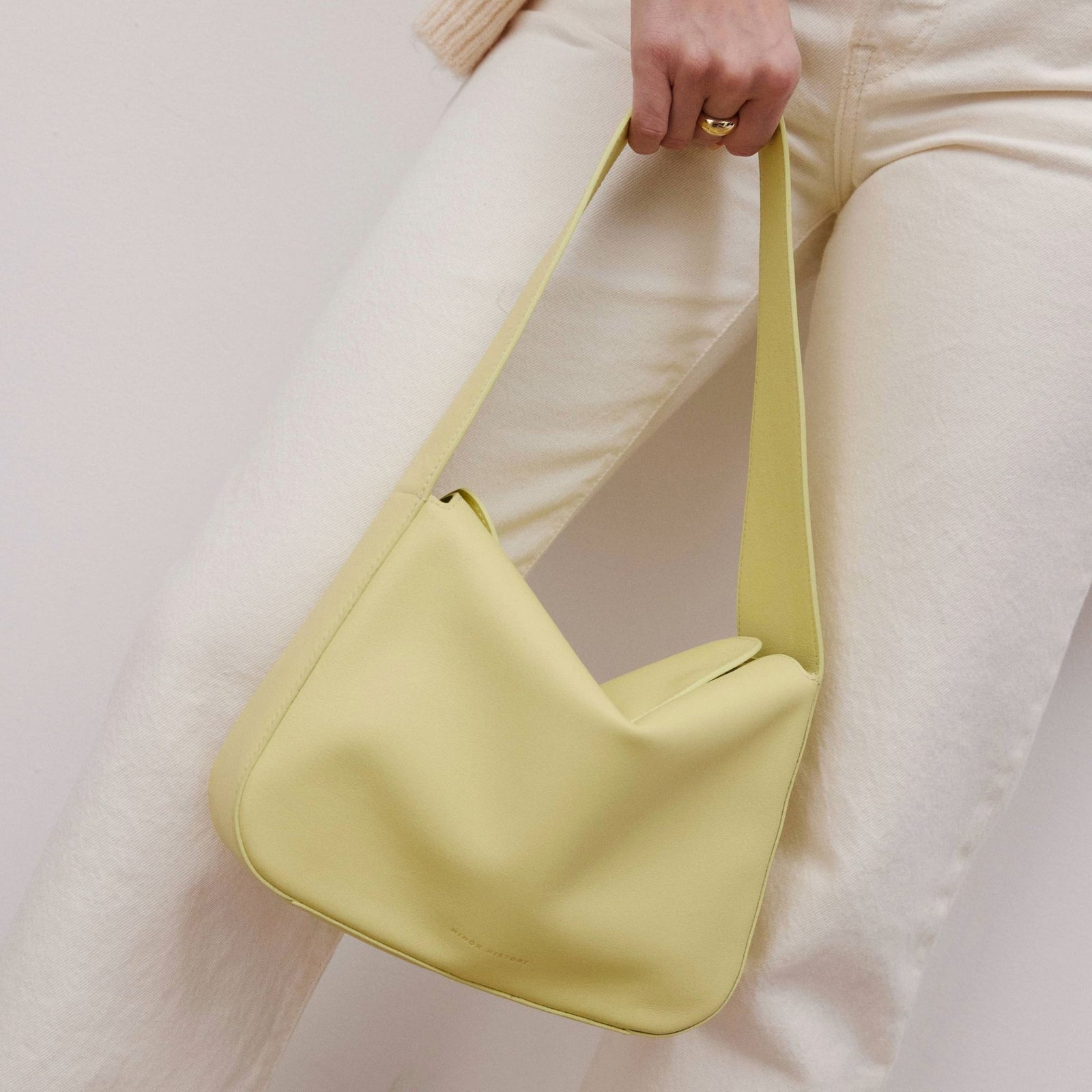 Frame Bag in luxury full-grain leather, minimalist women's handbag in a bright studio setting