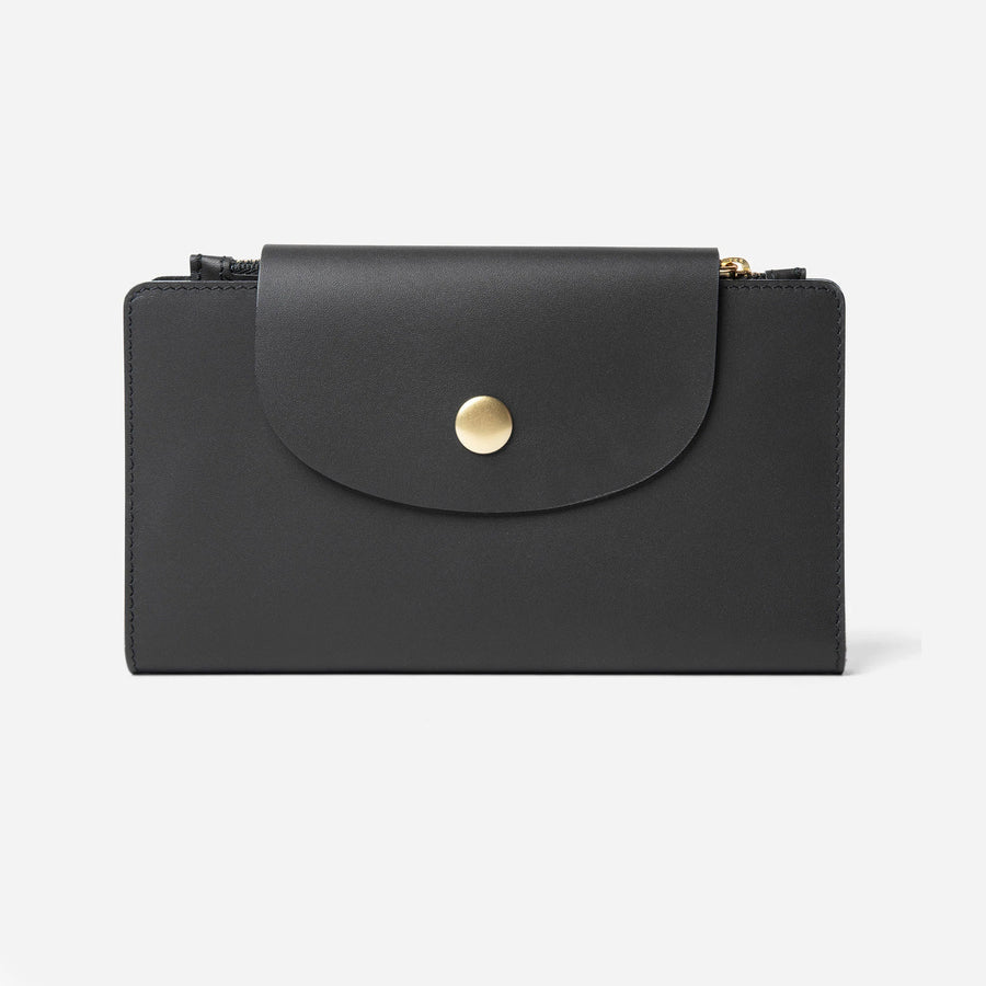 Black Runway Travel Wallet, closed front view showing the rounded snap flap - Black